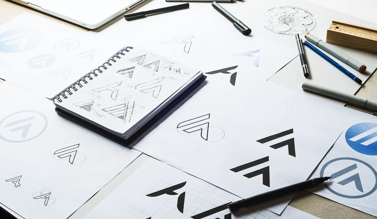 A close-up view showcases various logo designs that cleverly utilize negative space and hidden elements, revealing deeper meanings at first glance. Each logo features subtle hidden messages, such as a hidden arrow in the FedEx logo or the playful imagery in the Tostitos logo, highlighting the brand's visual identity and mission.